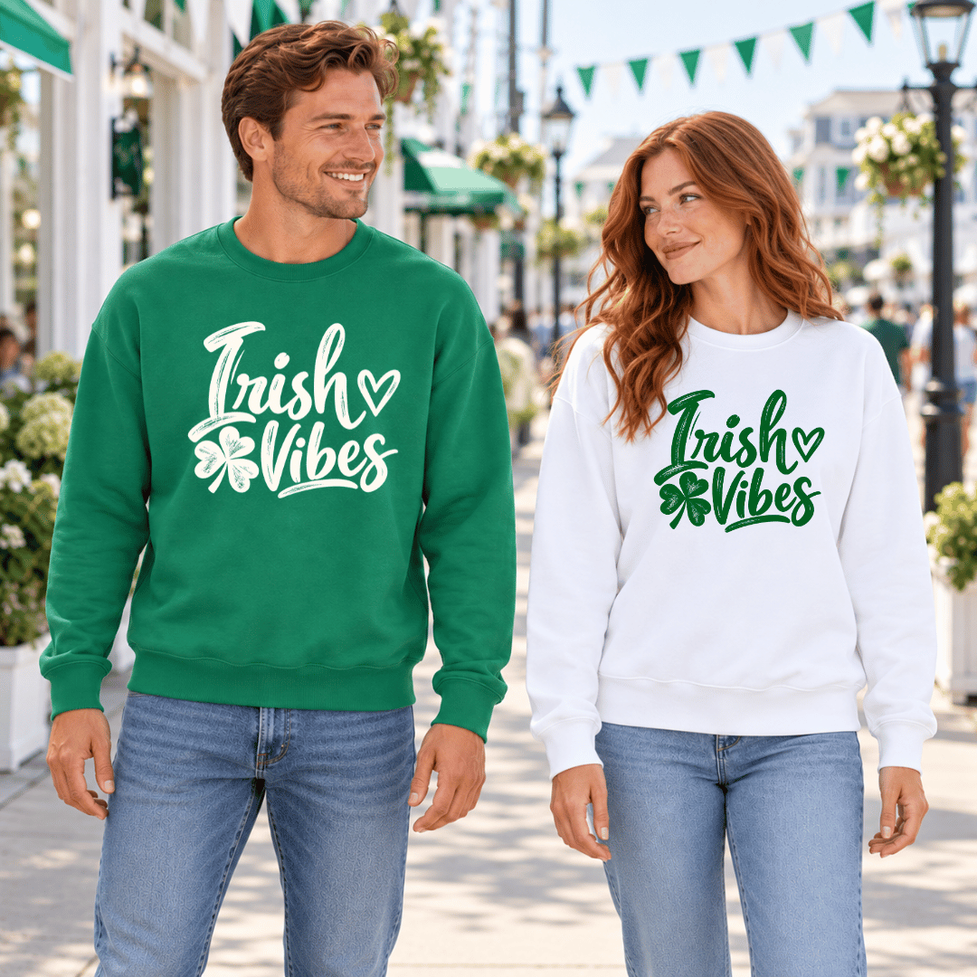 Man in a Kelly Green Irish Vibes sweatshirt beside a woman in the white version, showing both color options.