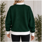 Back view of women’s dark green sweatshirt with white mock neck cuffs and waistband