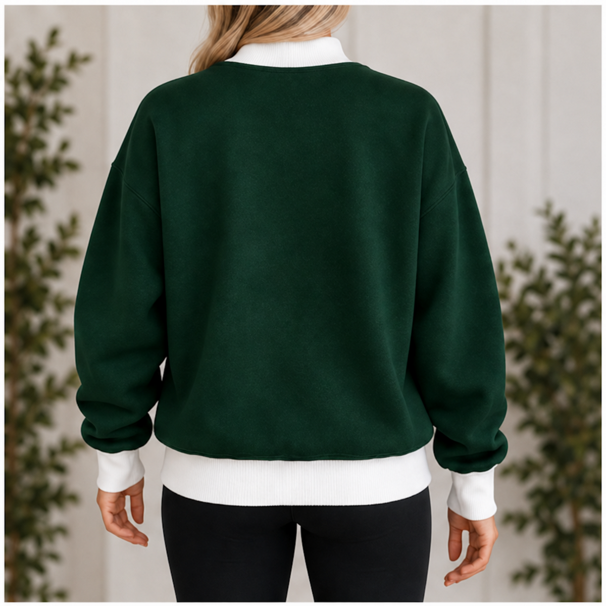 Back view of women’s dark green sweatshirt with white mock neck cuffs and waistband