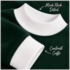 White ribbed mock neck and cuff details on dark green women’s sweatshirt