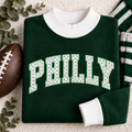 Folded dark green and white PHILLY polka dot mock neck sweatshirt for women