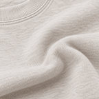 Close-up of Heather Dust sweatshirt fabric and ribbed neckline