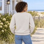 Back view of a woman wearing a plain Heather Dust crewneck sweatshirt near beach dunes