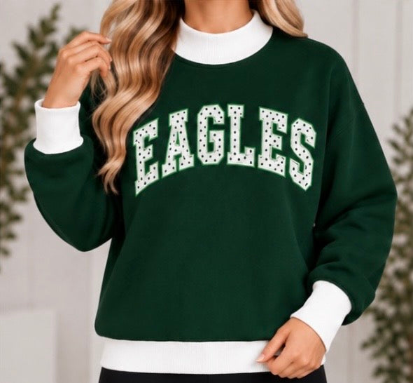Woman wearing dark green EAGLES polka dot game day mock neck sweatshirt