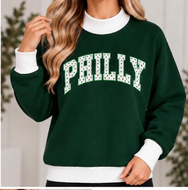 Woman wearing dark green PHILLY polka dot game day mock neck sweatshirt
