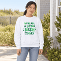 Woman wearing a white crewneck with green “We’re All a Little Irish Today” lettering and shamrocks