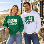 Woman wearing the Kelly Green Irish Vibes design and man wearing the white design beside an outdoor railing