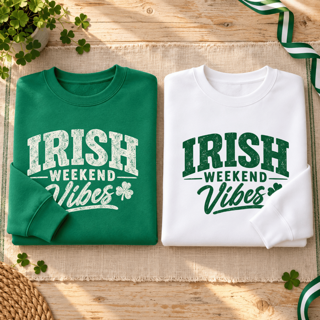 Folded Kelly Green and white sweatshirts showing their contrasting Irish Weekend Vibes graphics