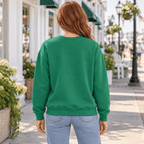 Back view of a woman wearing the plain Kelly Green Irish Vibes crewneck sweatshirt.
