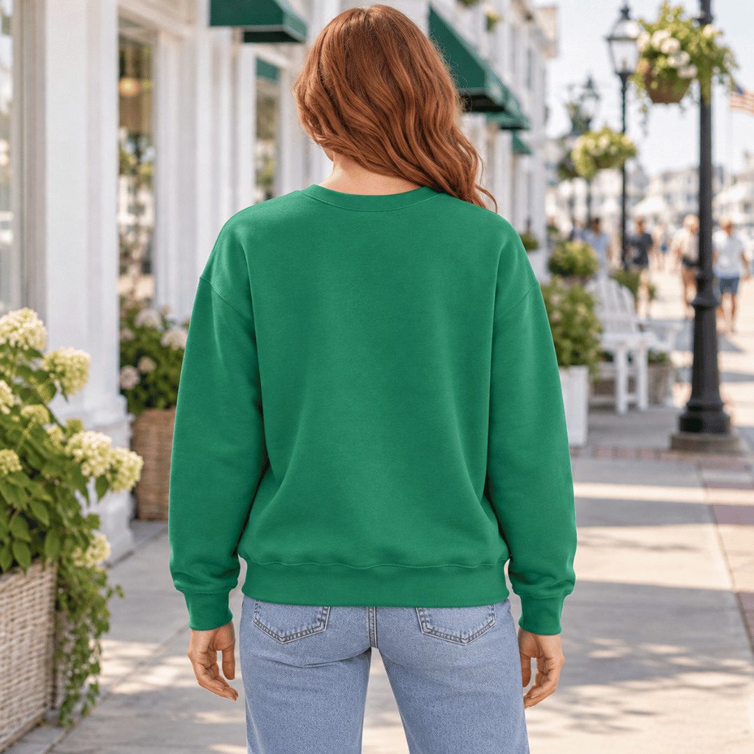Back view of a woman wearing the plain Kelly Green Irish Vibes crewneck sweatshirt.