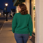 Back view of a woman wearing a plain Kelly Green crewneck sweatshirt outdoors at night
