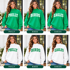 Women’s Philly mock neck sweatshirts in Kelly green and white with PHILLY, BIRDS and EAGLES designs