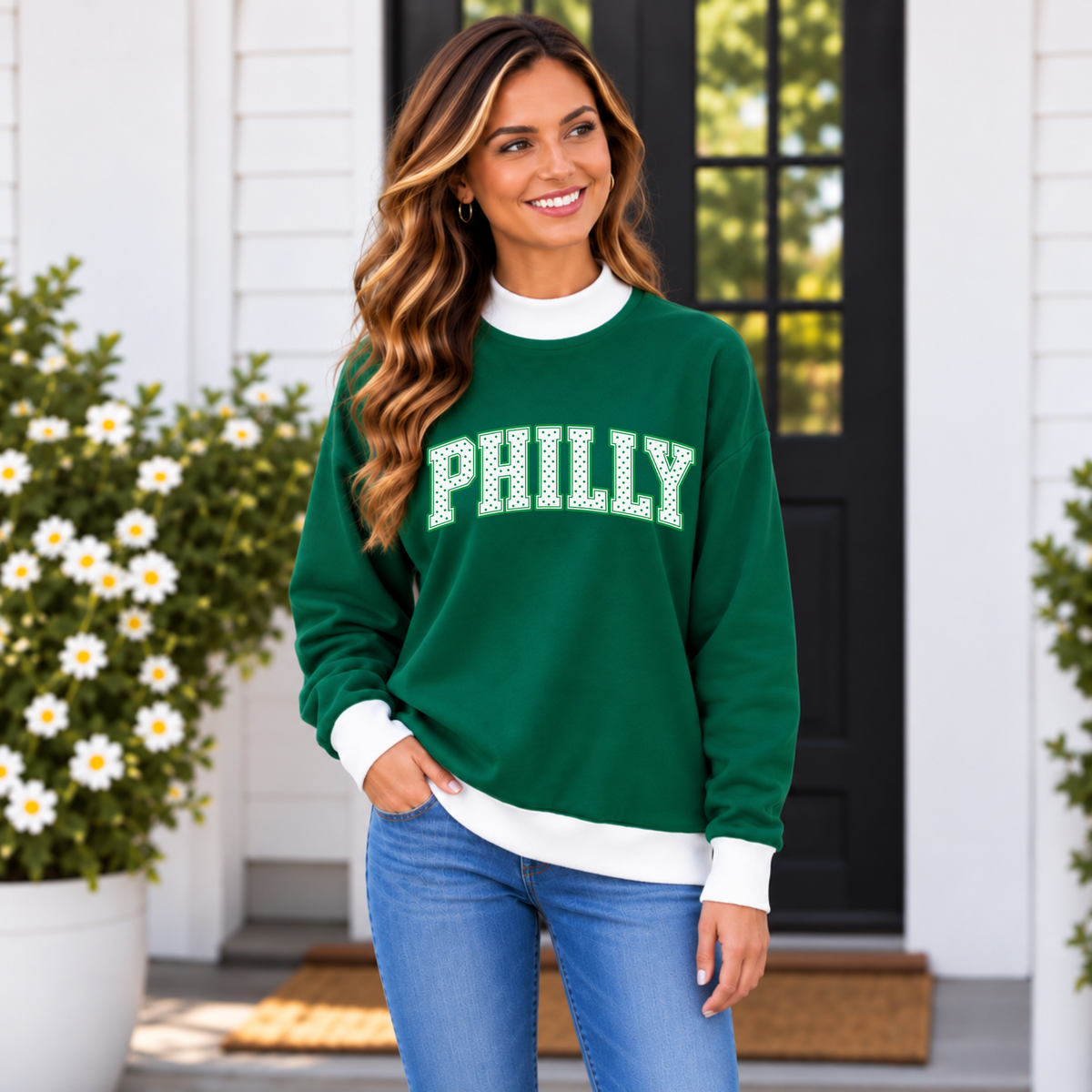 Woman wearing a green Philly mock neck sweatshirt with white polka dot lettering and contrast white trim