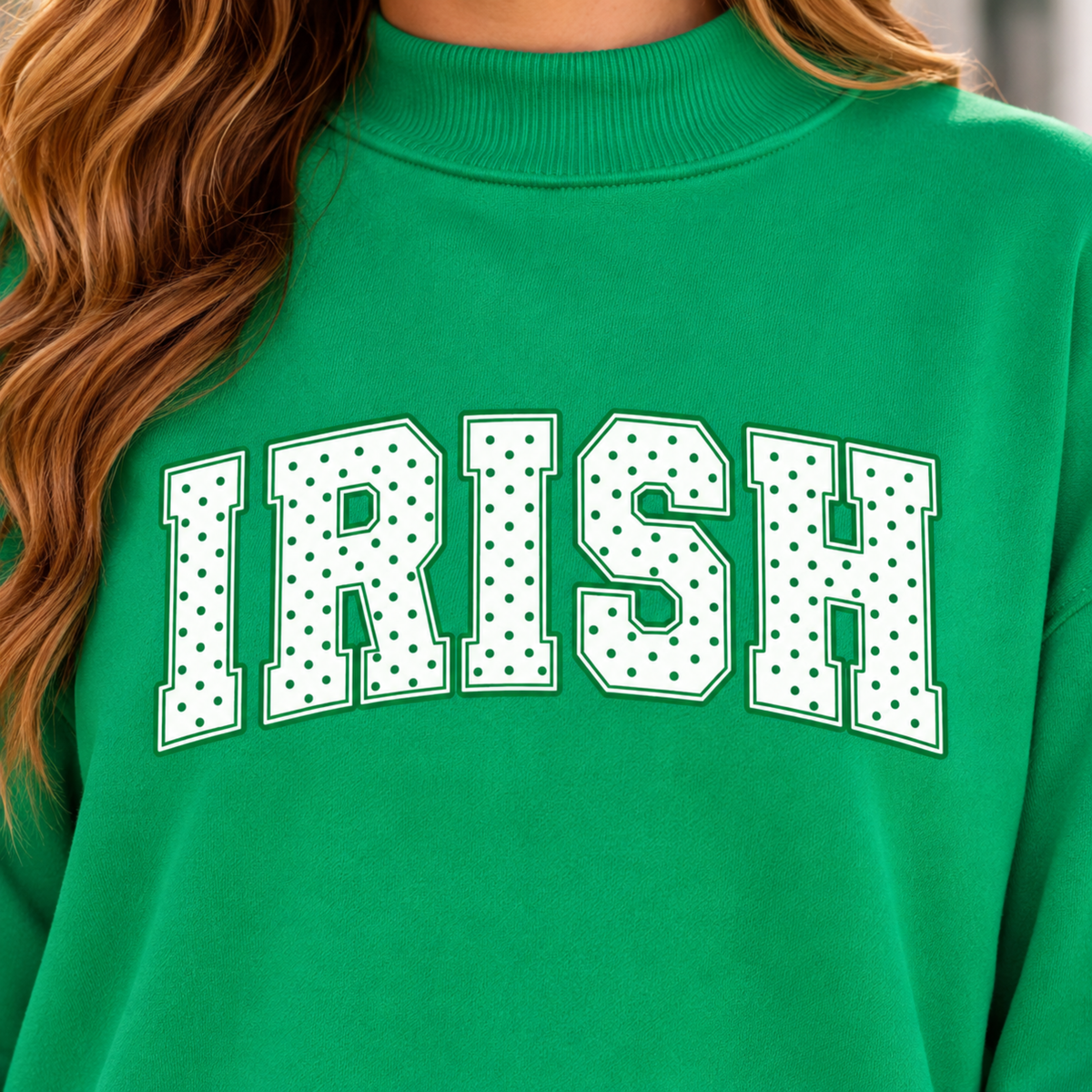Close-up of white IRISH polka dot lettering on Kelly green women’s mock neck sweatshirt