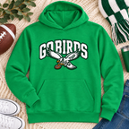 Kelly green pullover hoodie with white varsity GO BIRDS lettering and an eagle carrying a football, laid flat on a knit blanket with a football, green and white scarf, jeans and white sneakers