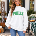 Women’s white Philly mock neck sweatshirt with green PHILLY polka dot lettering for football game day