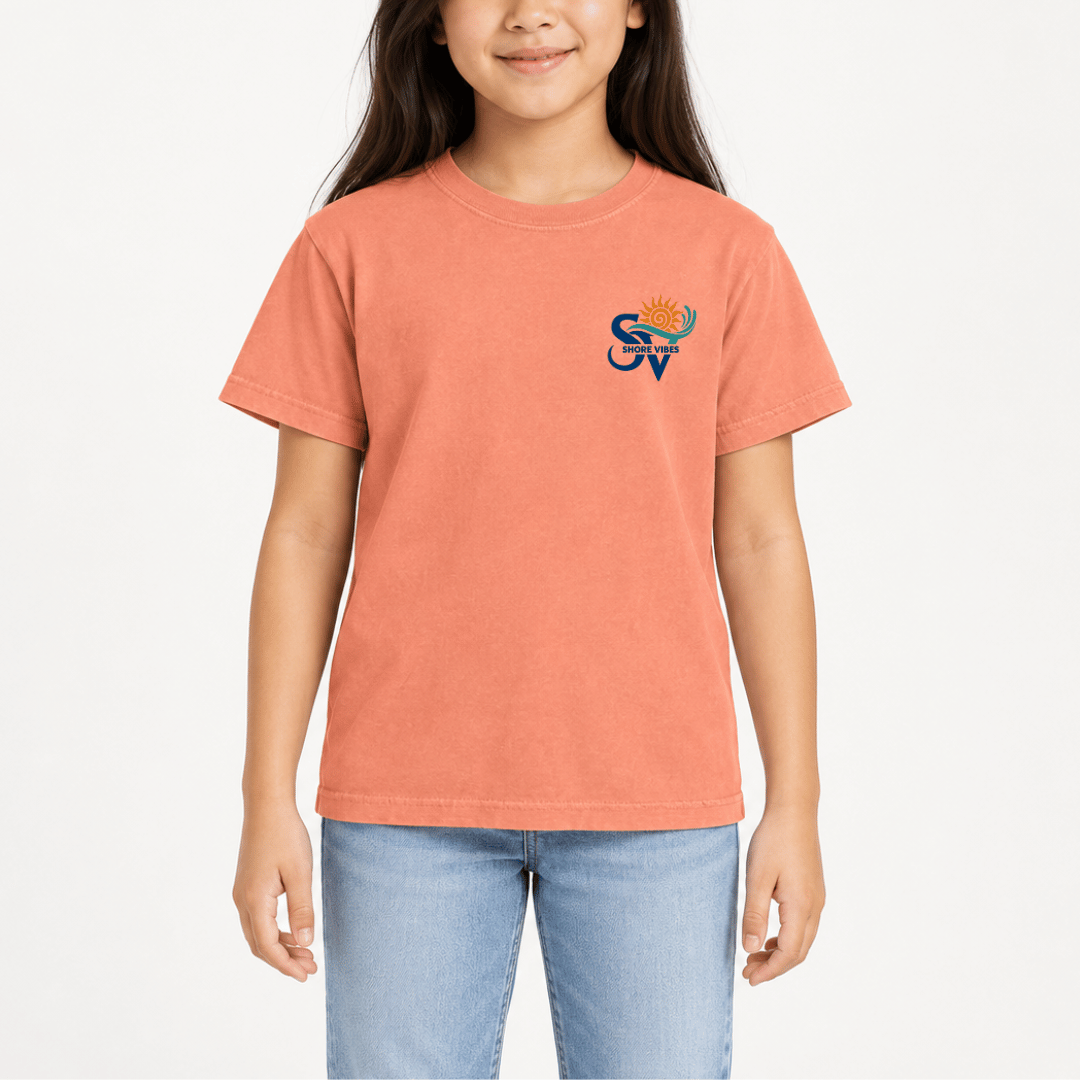 Girl wearing a Melon orange Shore Vibes t-shirt with the front logo, studio photo