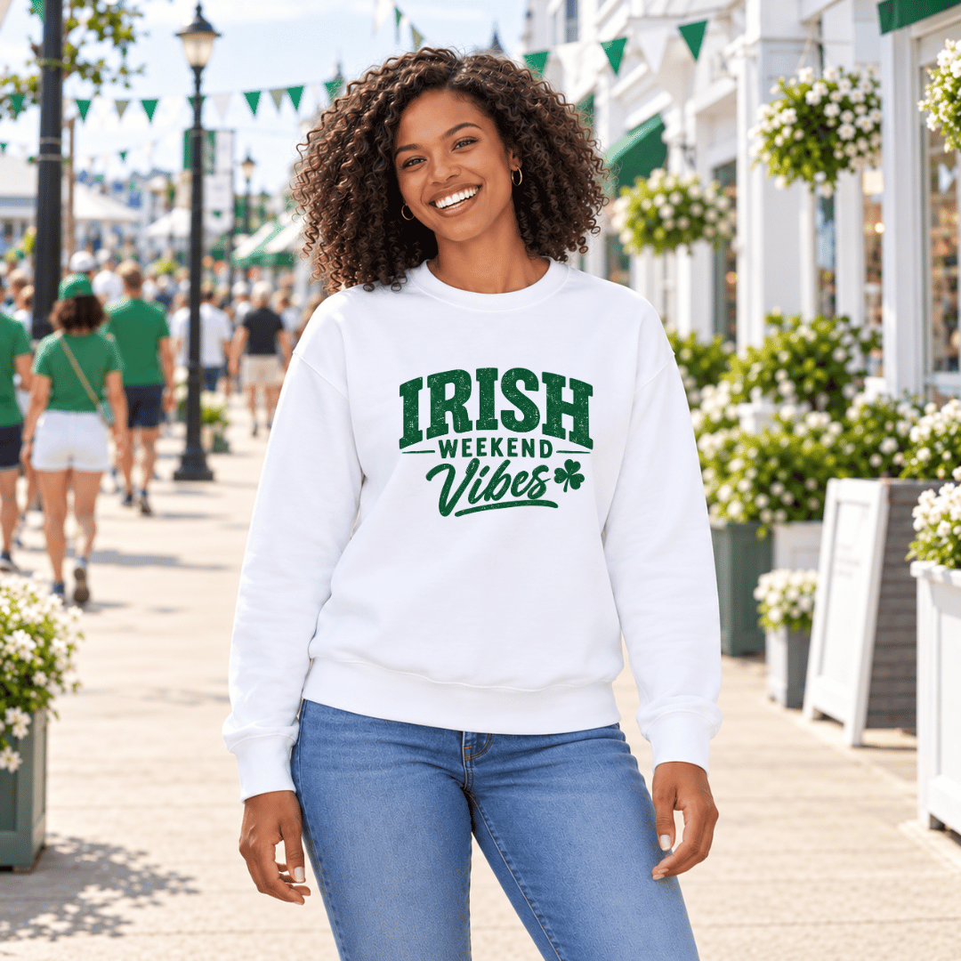 Woman wearing a white crewneck sweatshirt with a green Irish Weekend Vibes graphic