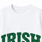 Close-up of green distressed IRISH lettering, WEEKEND text, Vibes script and shamrock on a white sweatshirt