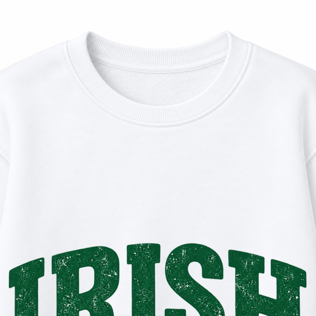Close-up of green distressed IRISH lettering, WEEKEND text, Vibes script and shamrock on a white sweatshirt