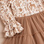 Close-up of the beige woodland animal print, layered ruffle cuff and tan tulle skirt