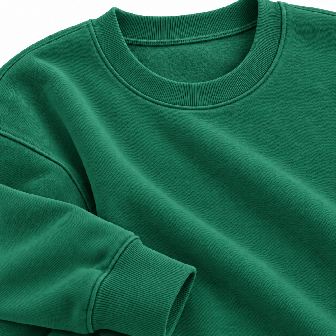 A close-up of a kelly green crewneck sweatshirt showing the ribbed collar and sleeve cuff, with the fabric texture clearly visible.