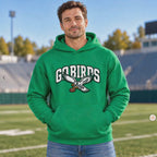 Man wearing a Kelly Green hoodie with white "GO BIRDS" varsity lettering and a flying eagle graphic holding a football