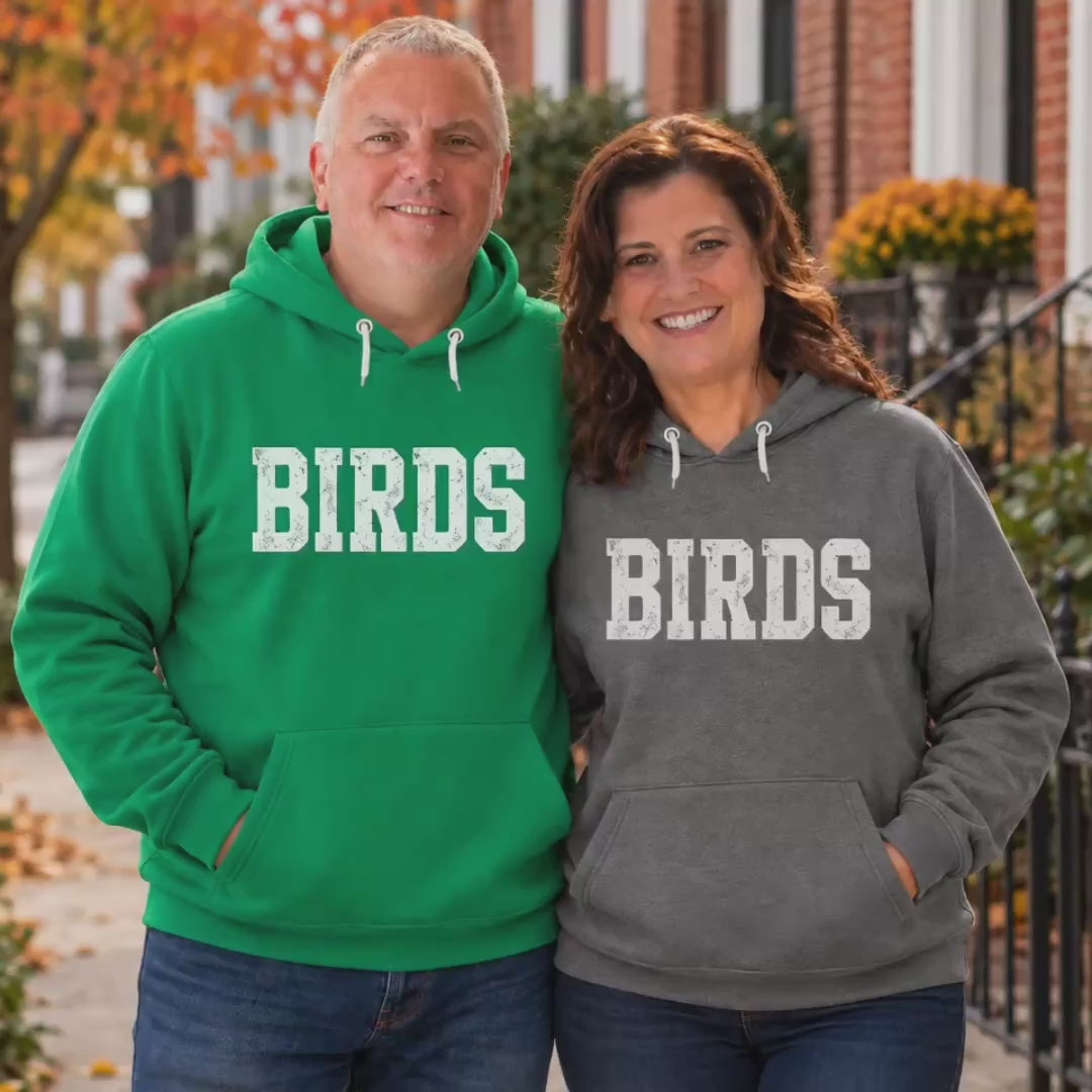 Video of a man and woman in matching Birds hoodies in Kelly green and Deep Heather on a fall day
