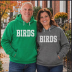 Video of a couple wearing Birds hoodies in Kelly green and Deep Heather, Philly football game day sweatshirts by Shore Vibes by Maria